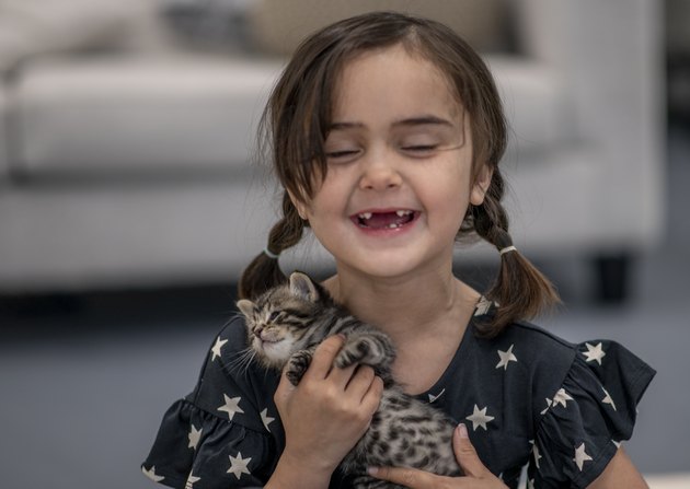 Little girl and her kittens.