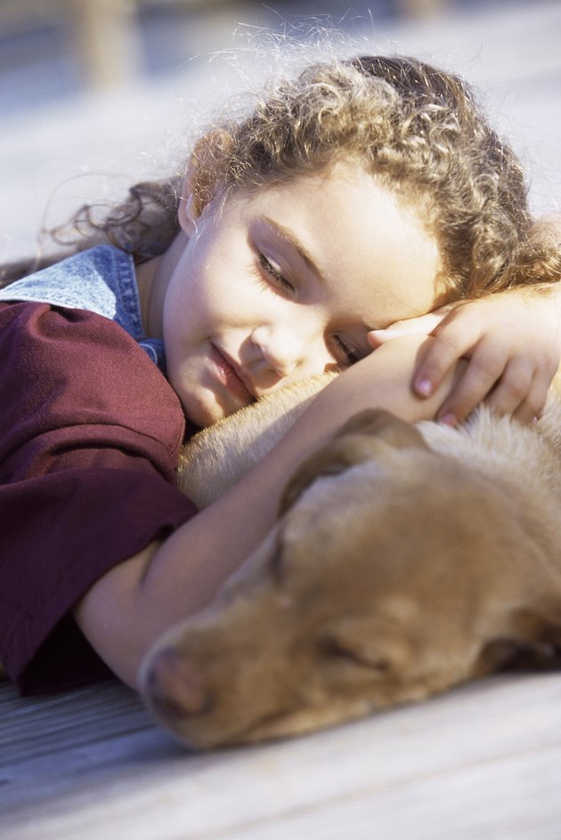 Close-up of a girl sleeping with her dog