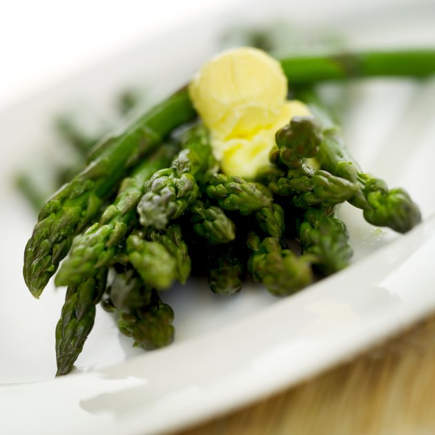 close-up of green beans with a blob of butter on a plate