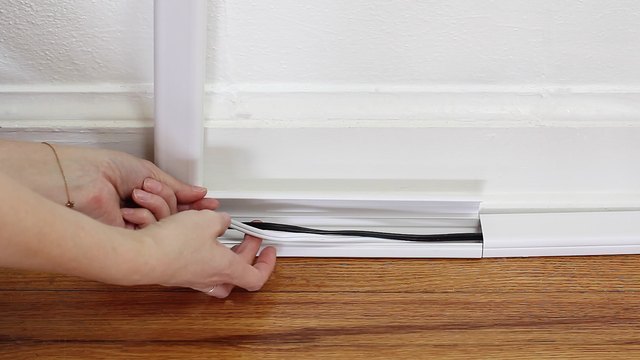 Tucking electrical cords into a cord cover