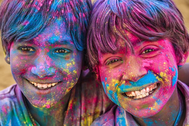 Group of happy Indian boys playing holi, desert village, India
