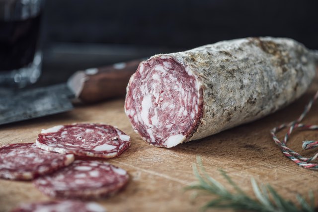 Sliced salami on cutting board