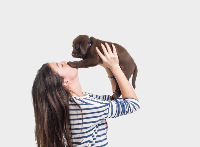 Side view of woman playing with her dog