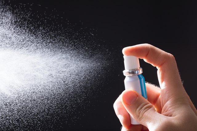 Person Spraying Breath Freshener