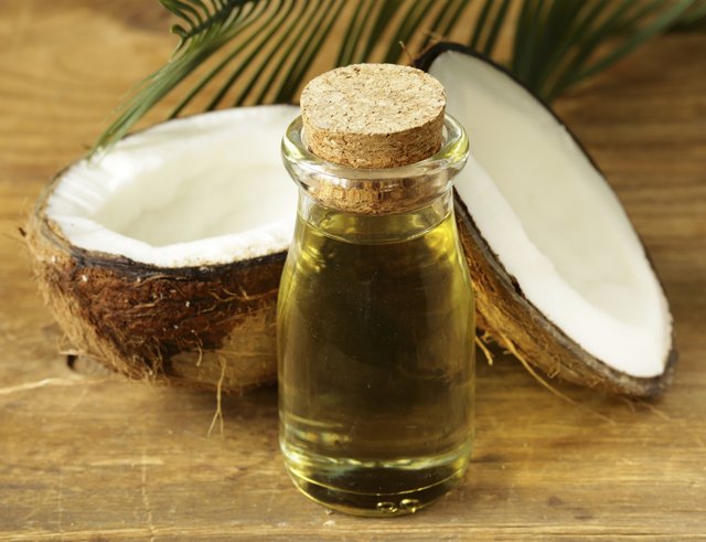 coconut oil in a glass bottle and fresh nuts